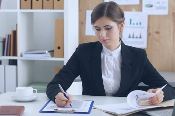female cfo at desk working with files